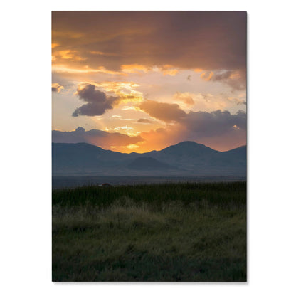 Vertical poster featuring a mountain landscape at sunset with golden clouds and dark grassy foreground wall art.