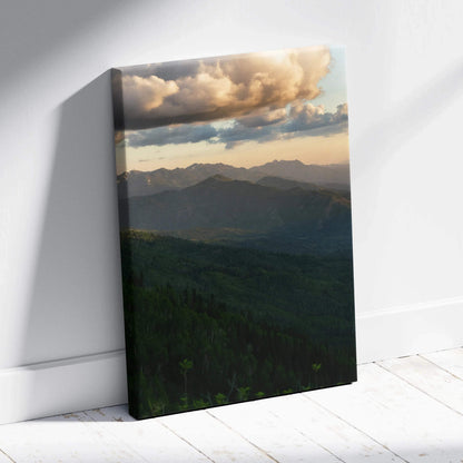 Vertical canvas wall art featuring a mountain landscape at sunset with dramatic clouds and soft light.