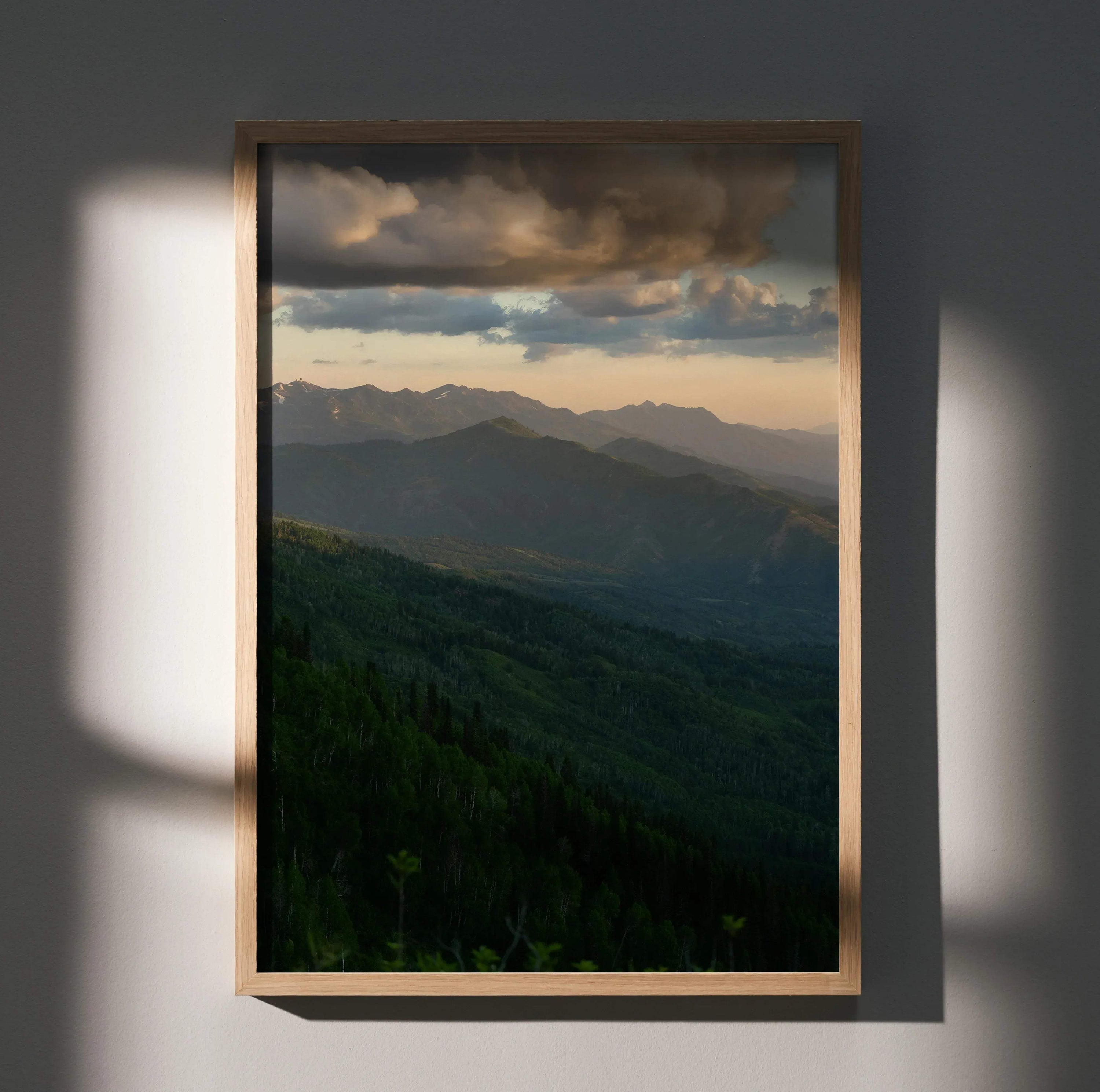 Mountain sunset poster with layered peaks and dramatic clouds, vertical wall art.
