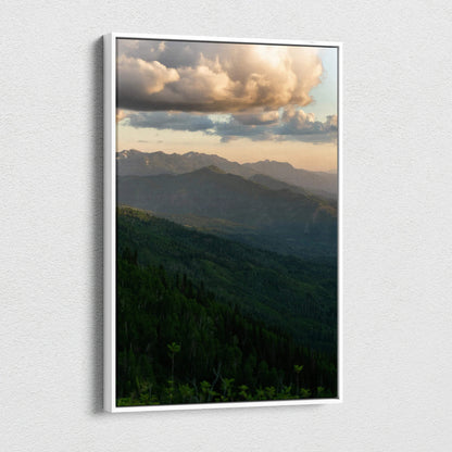 Vertical canvas wall art featuring a serene mountain landscape at sunset with dramatic clouds.