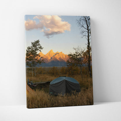 Canvas wall art featuring a mountain sunset with golden light, trees, and a tent in a natural landscape.