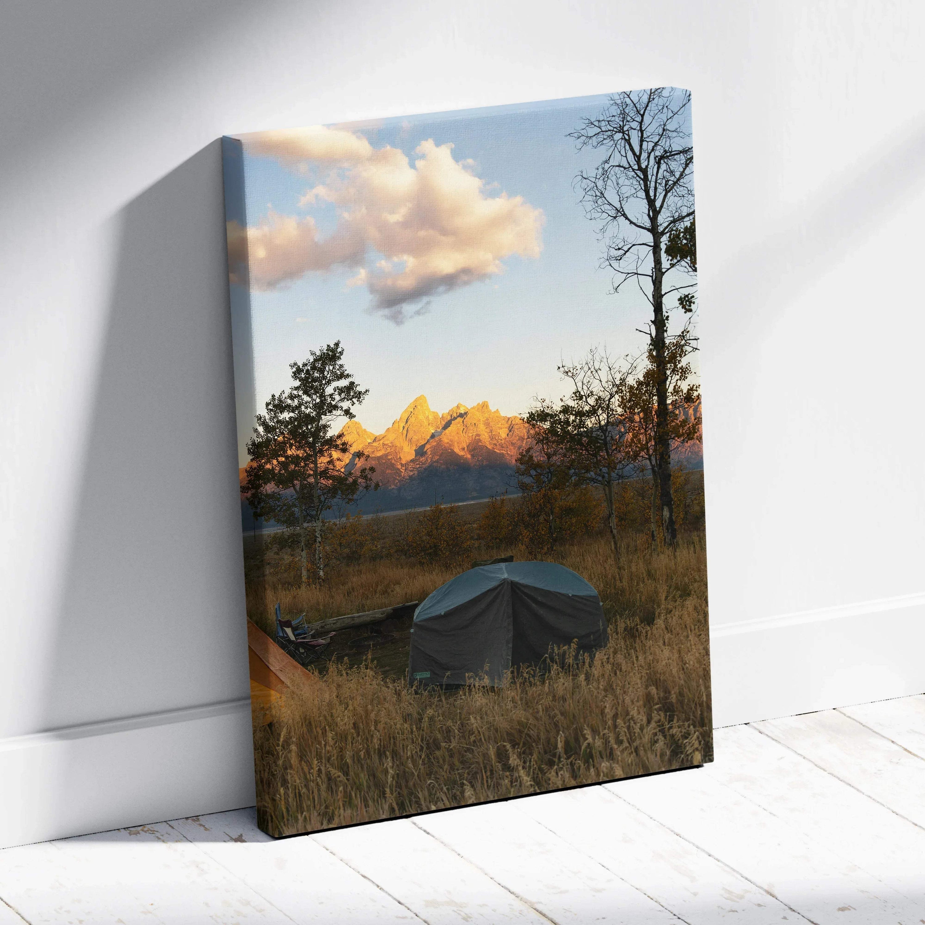 Canvas wall art featuring a sunset over mountains with trees and a covered boat in foreground.