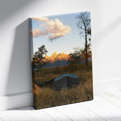 Canvas wall art featuring a sunset over mountains with trees and a covered boat in foreground.