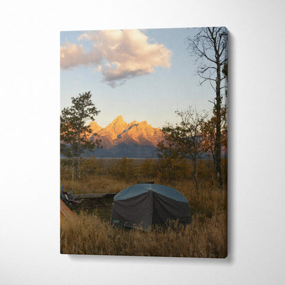 Canvas wall art featuring a tent in a field with golden mountains at sunset and trees.