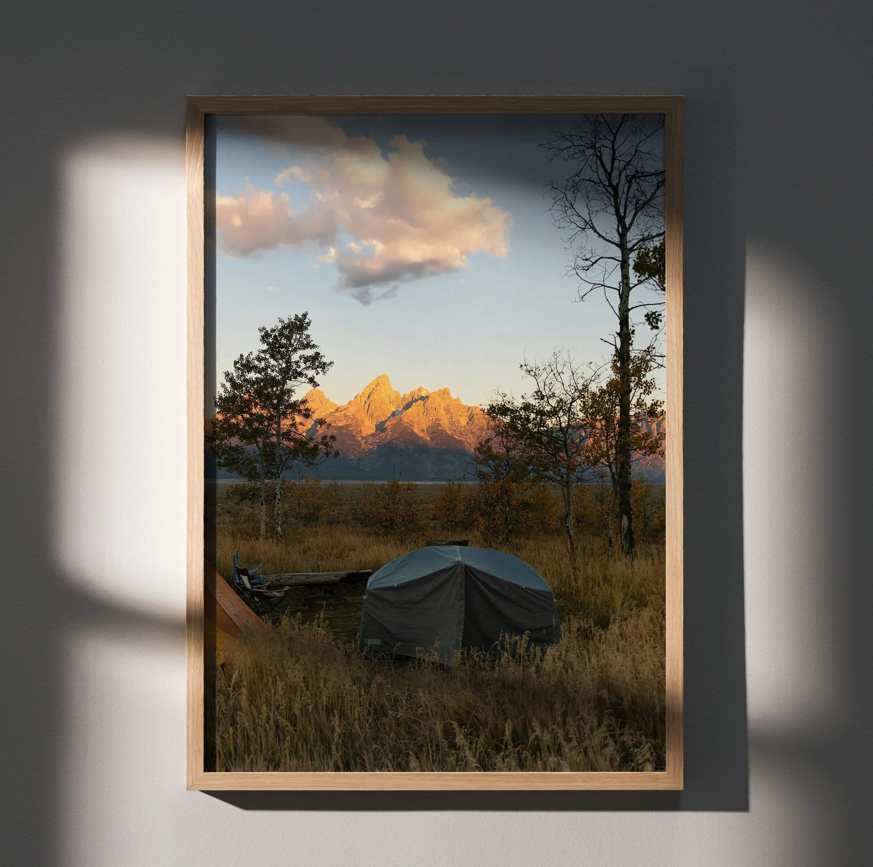 Vertical wall art poster featuring majestic mountain peaks at sunset with warm golden light and a foreground tent in a.