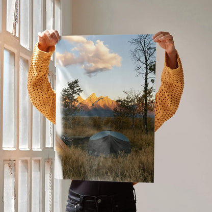 Vertical wall art poster featuring a sunset over majestic mountain peaks with a tent in the foreground.