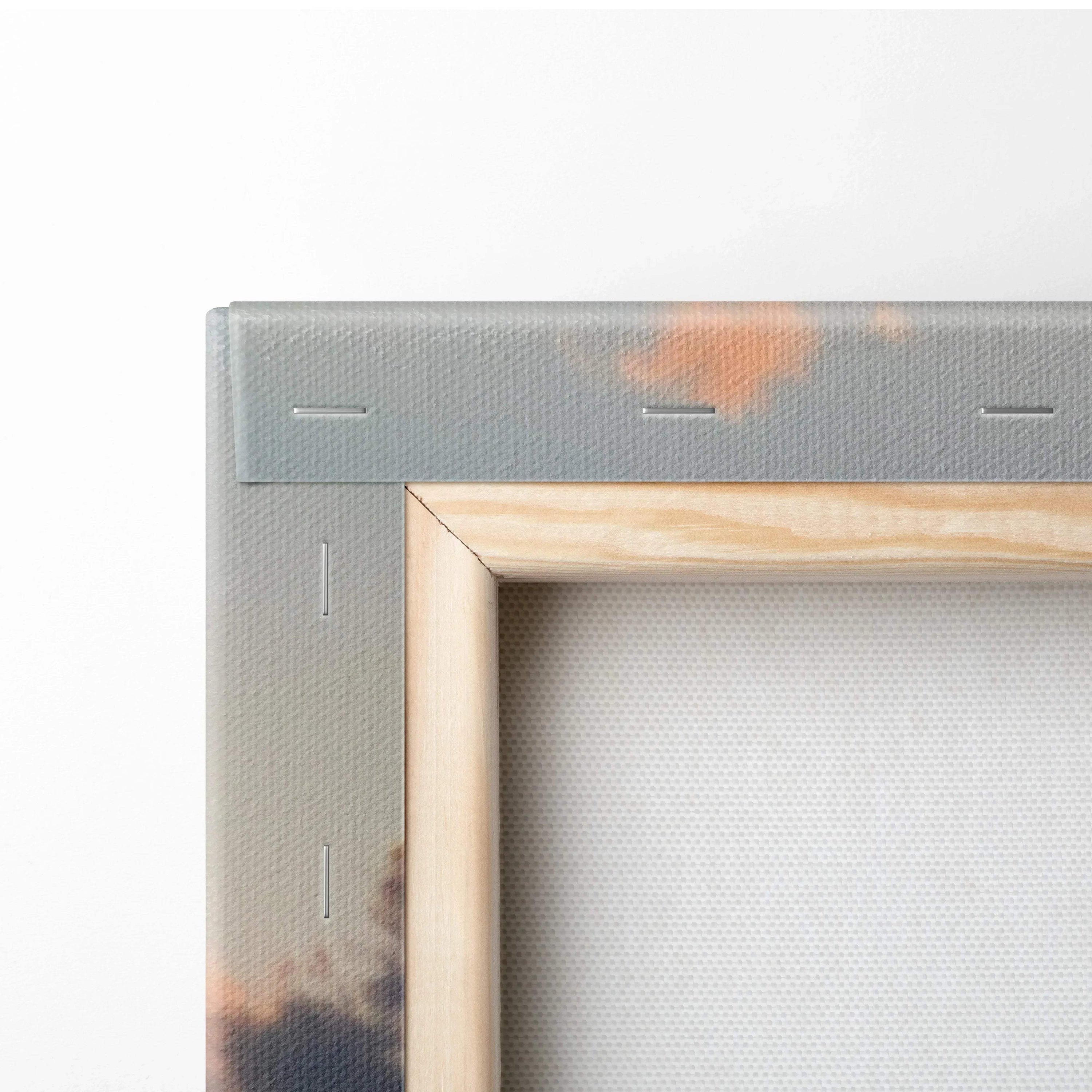 Close-up of wooden frame corner with beige canvas stretched and secured with staples for wall art.
