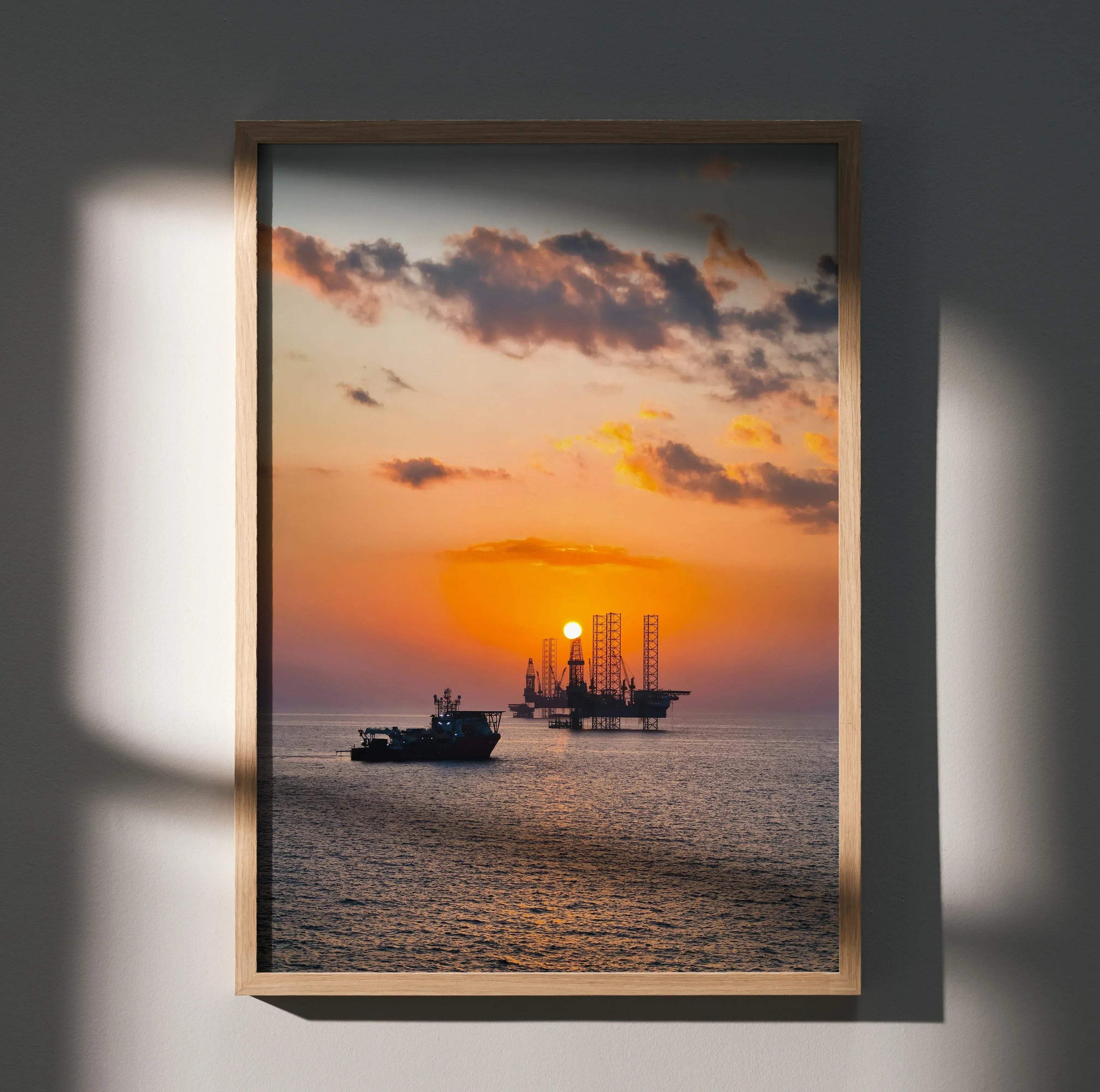 Vibrant ocean sunset poster with silhouetted oil rig and boat, vertical wall art in warm tones.