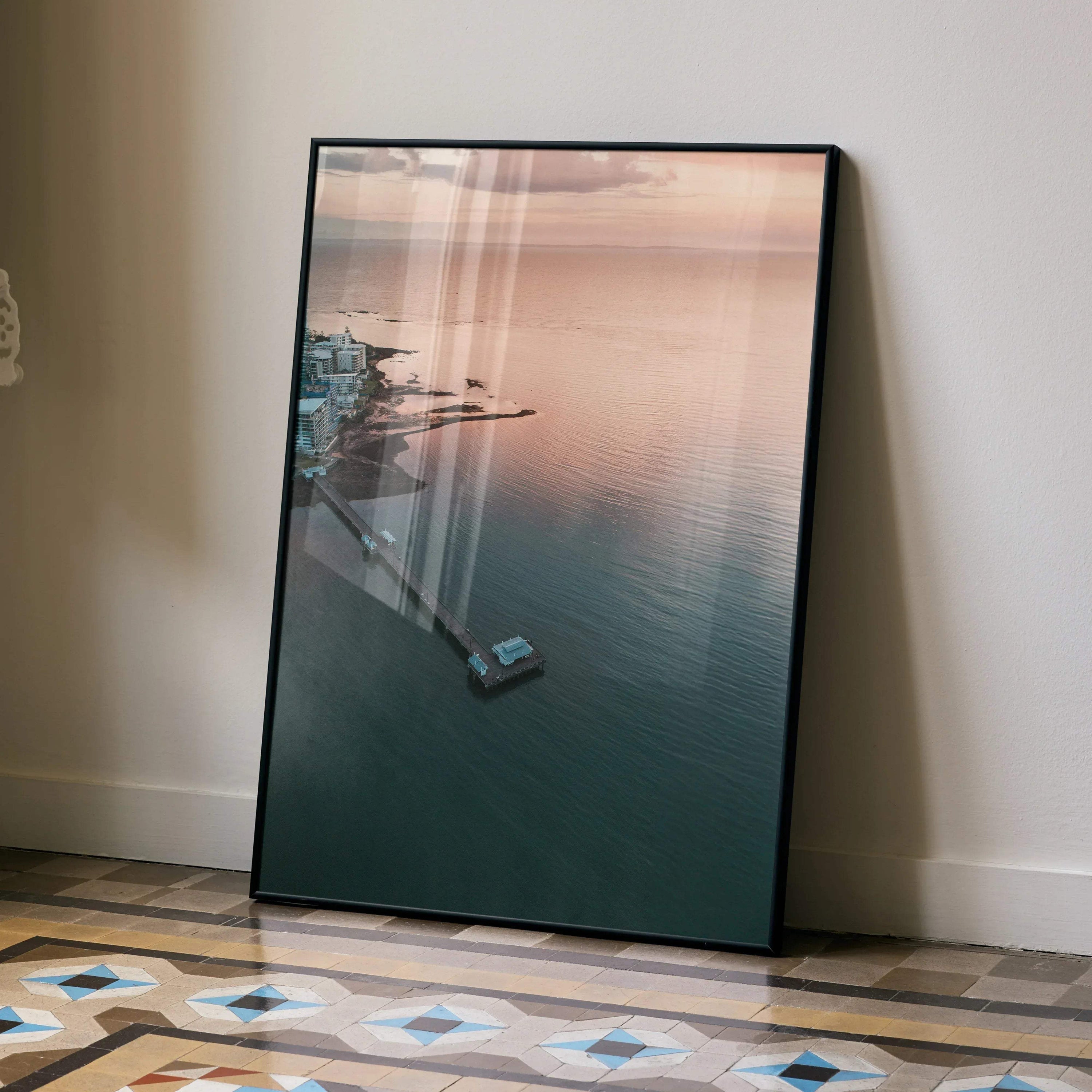 Ocean sunset poster featuring serene water and silhouetted coastline in soft pastel tones, vertical wall art.