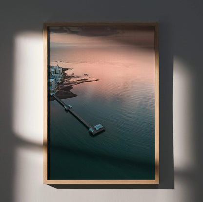 Vertical ocean sunset poster with calm water, pier, and soft pink sky wall art.