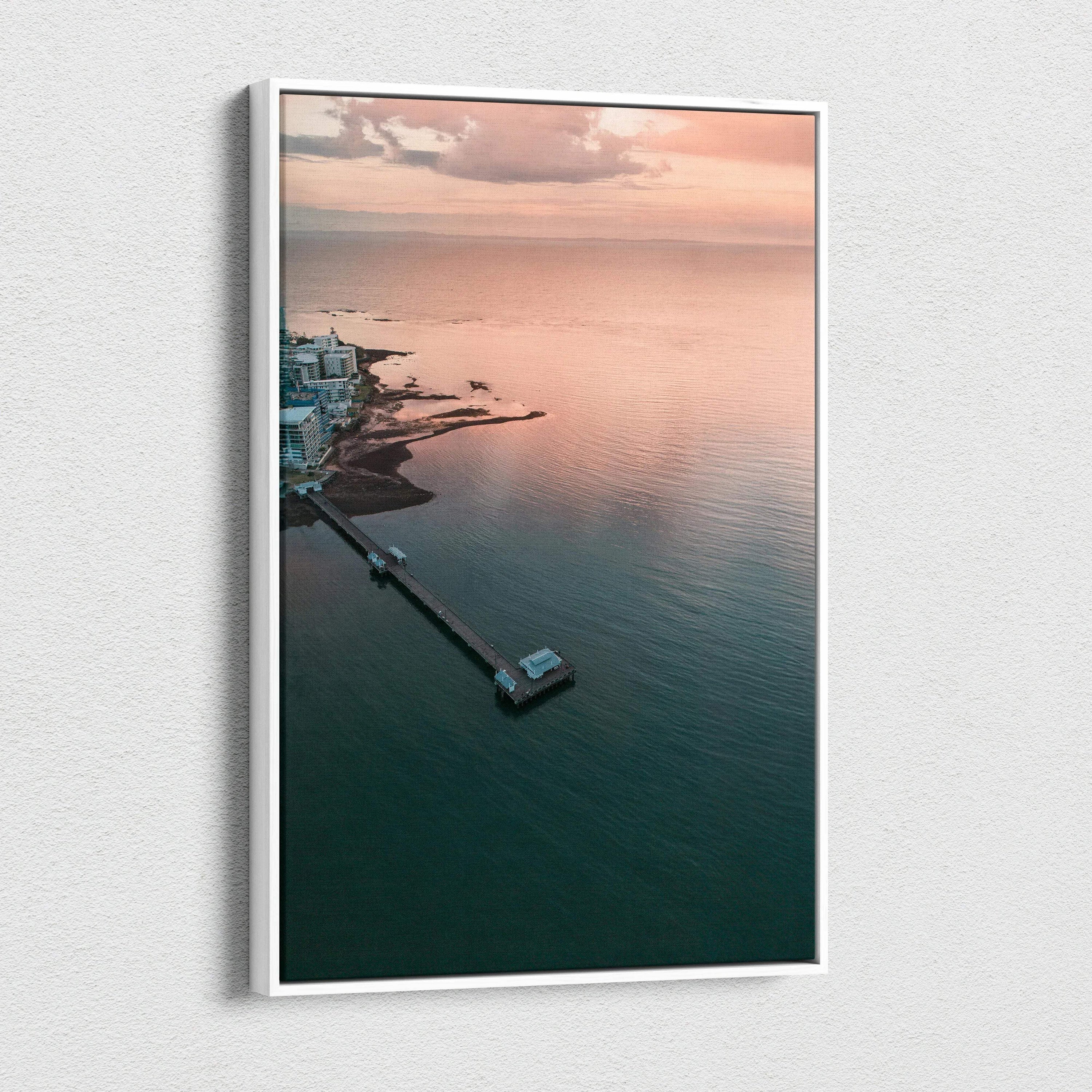 Vertical canvas wall art featuring a serene ocean sunset over a calm beach with soft pastel skies.
