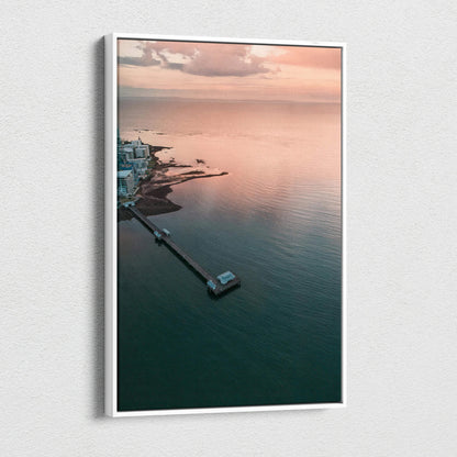 Vertical canvas wall art featuring a serene ocean sunset over a calm beach with soft pastel skies.