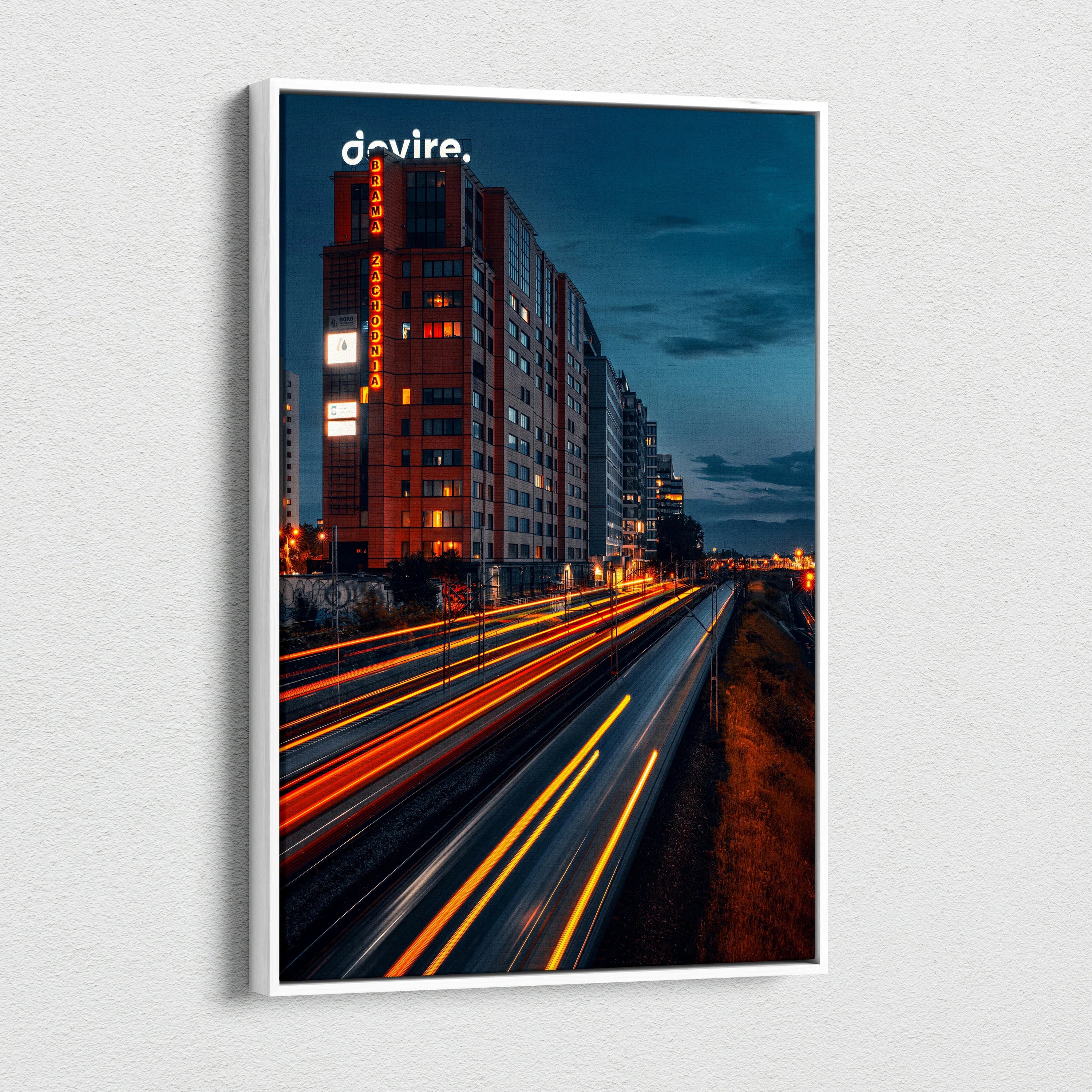 Vibrant urban cityscape canvas wall art featuring illuminated buildings and light trails at dusk.