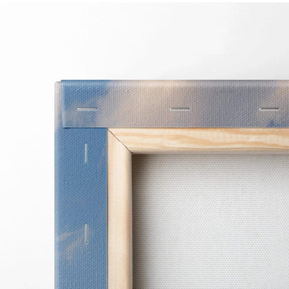 Close-up of wooden frame and blue edge of stretched canvas wall art with taut fabric back.