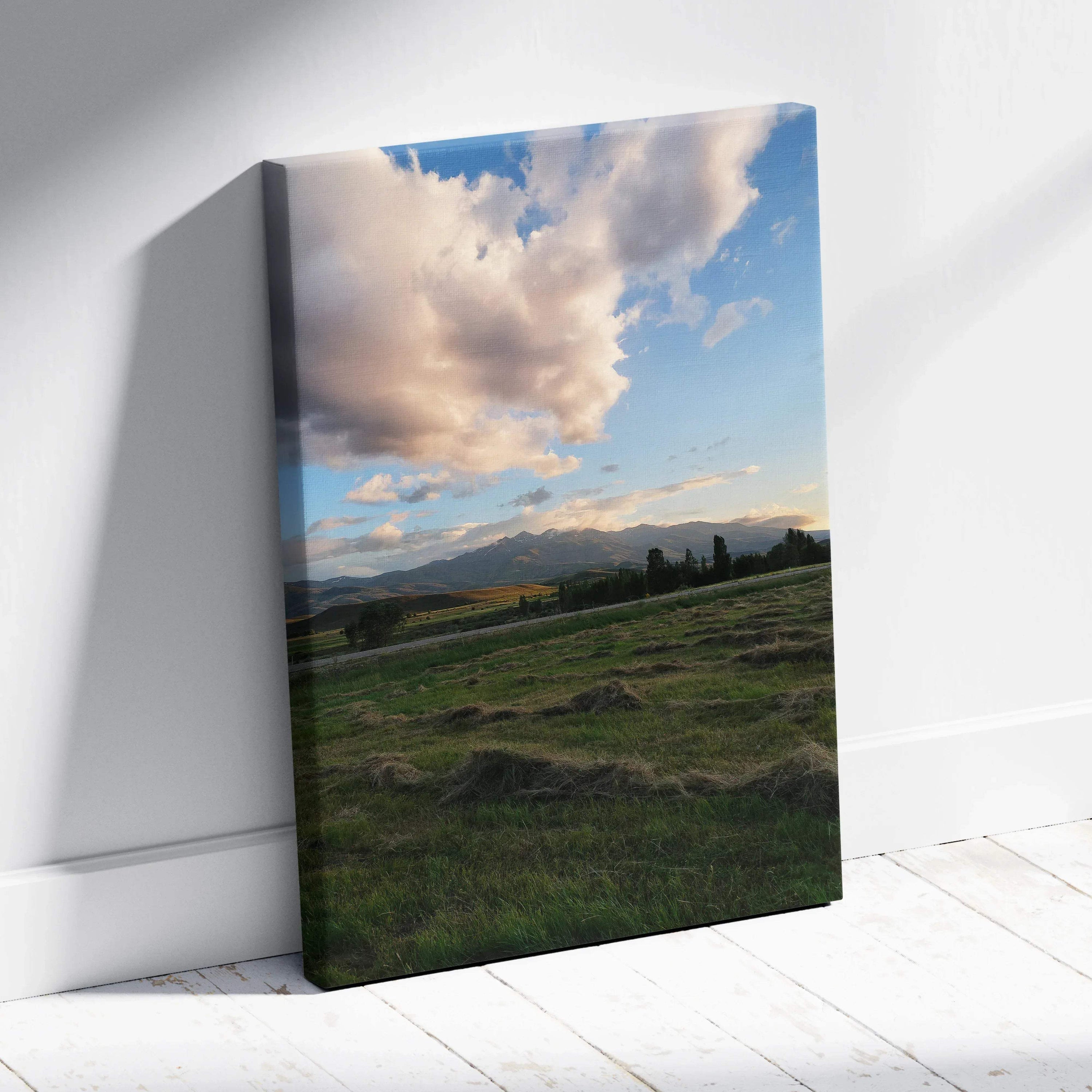 Canvas wall art featuring a vibrant mountain sunset with dramatic clouds over green fields.