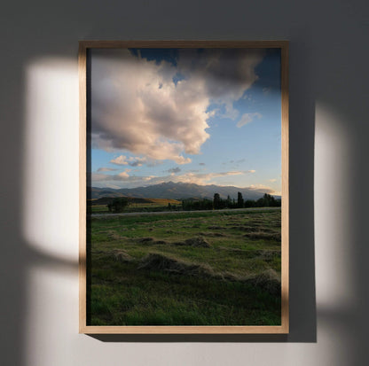 Vertical mountain sunset nature poster with vibrant sky and green fields wall art.