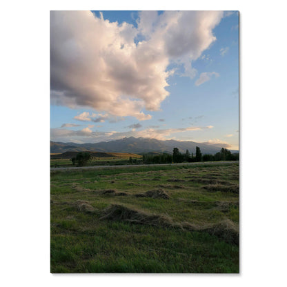 Vertical poster of mountain range under a colorful sunset sky with clouds, nature wall art.