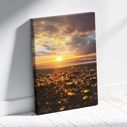 Canvas wall art featuring a glowing beach sunset with golden light reflecting on wet sand.