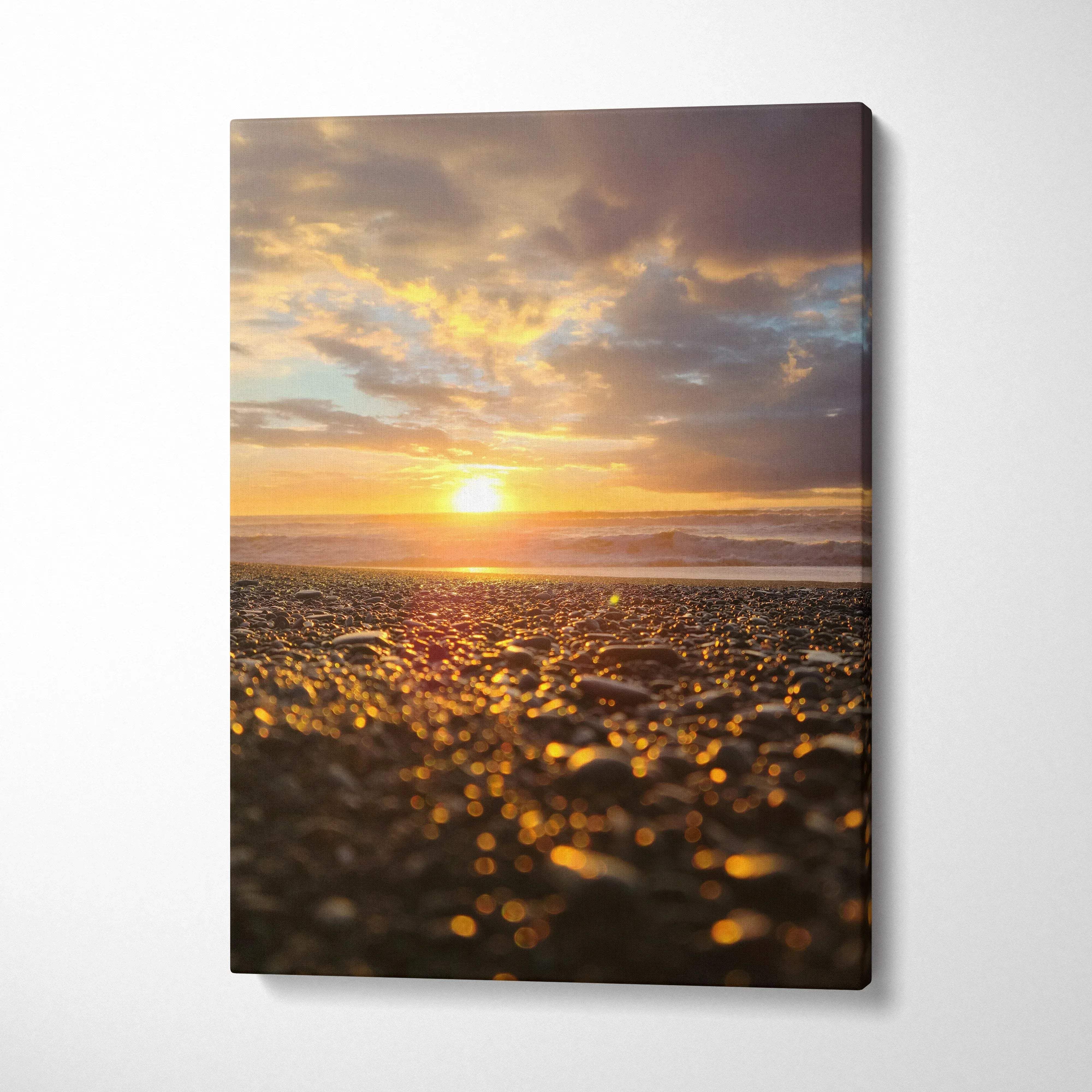 Canvas wall art featuring a golden beach sunset with detailed pebbles and vibrant sky colors.
