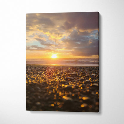 Canvas wall art featuring a golden beach sunset with detailed pebbles and vibrant sky colors.
