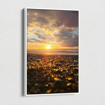 Vertical canvas wall art featuring a vibrant beach sunset with golden sunlight and cloudy sky.
