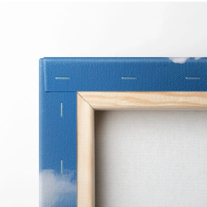 Close-up of blue canvas stretched over wooden frame with visible staples for wall art.