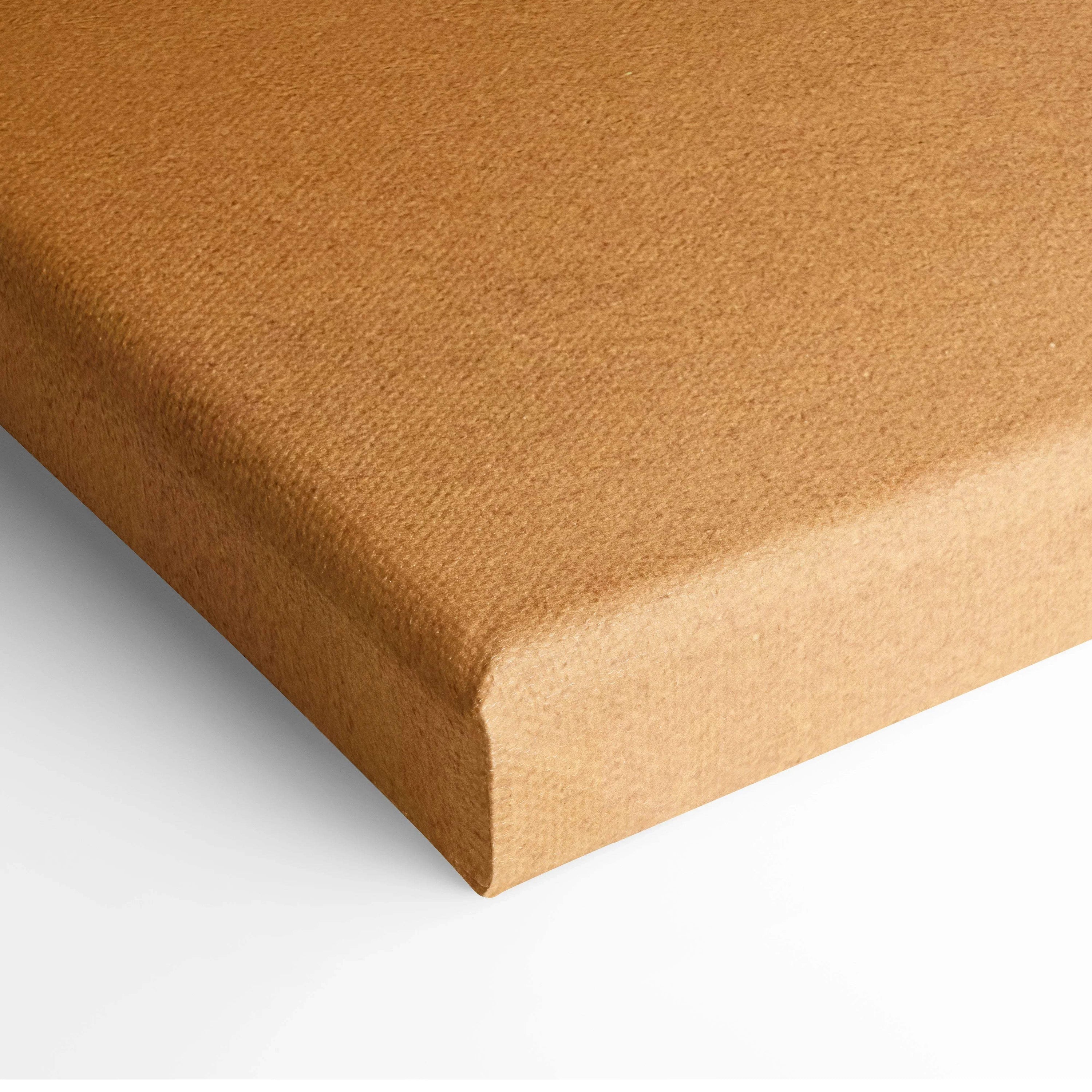 Close-up of wrapped canvas edge in muted brown tones, ready for wall art display.