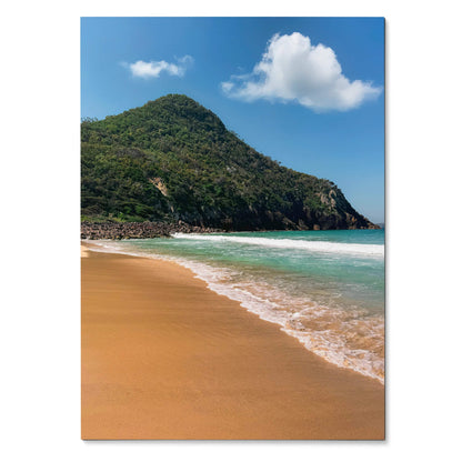 Serene beach scene poster with turquoise ocean, golden sand, and green hill against blue sky wall art.