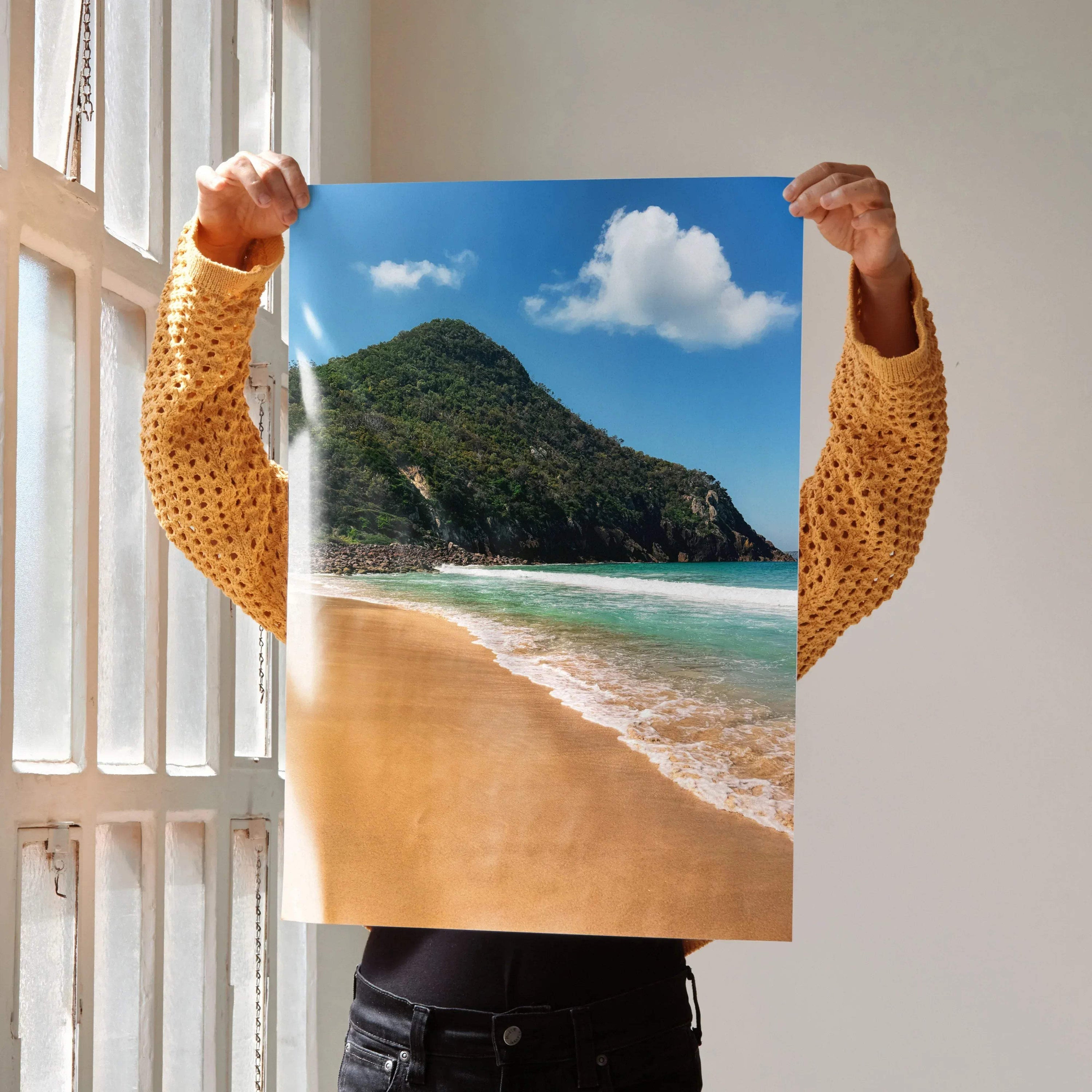 Serene beach poster with sandy shore, turquoise ocean, and green hillside wall art.