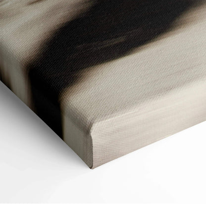 Close-up of textured canvas wall art corner with soft beige and dark abstract brushstrokes.