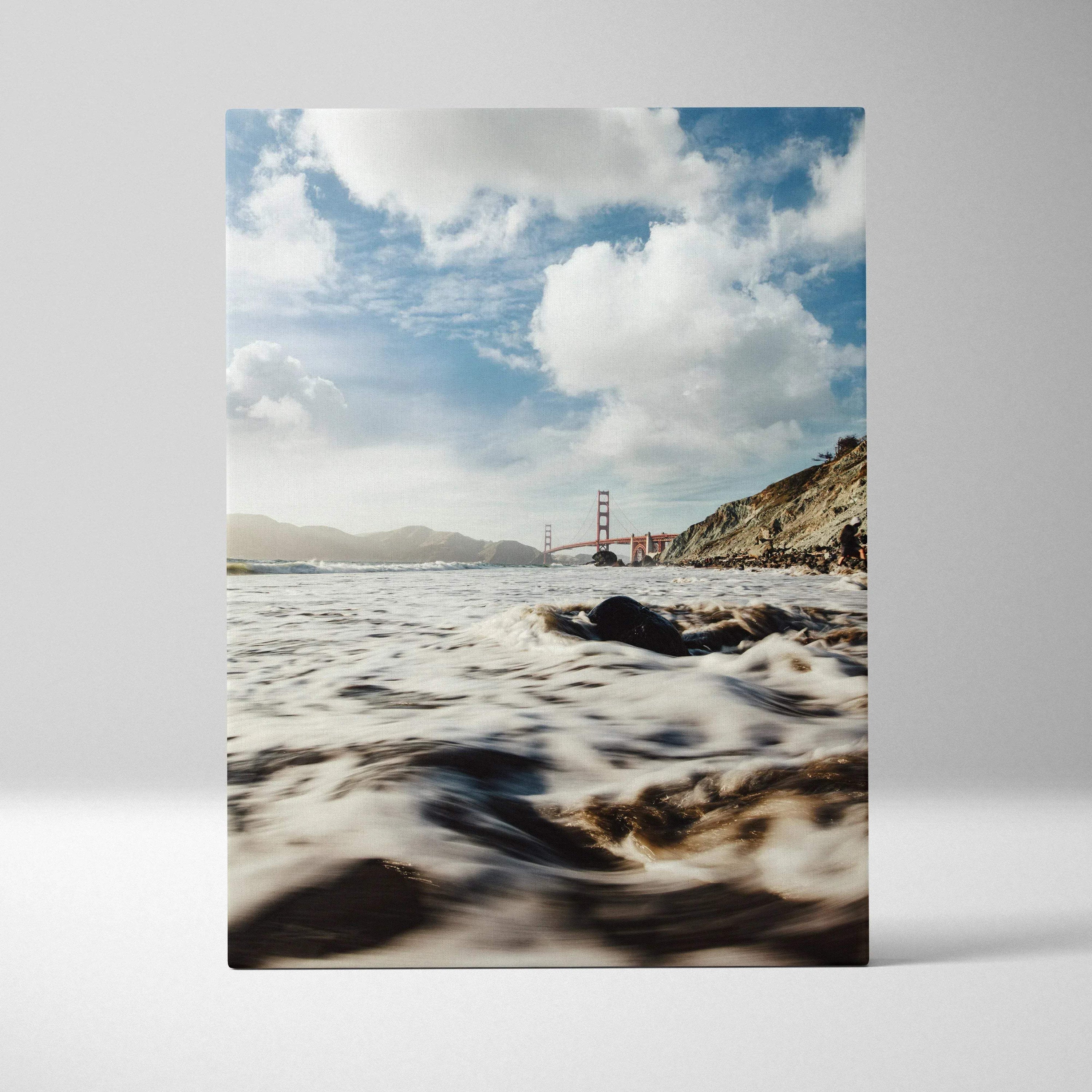 Canvas wall art featuring the Golden Gate Bridge with waves and cloudy sky.
