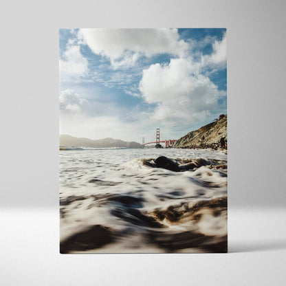 Canvas wall art featuring the Golden Gate Bridge with waves and cloudy sky.