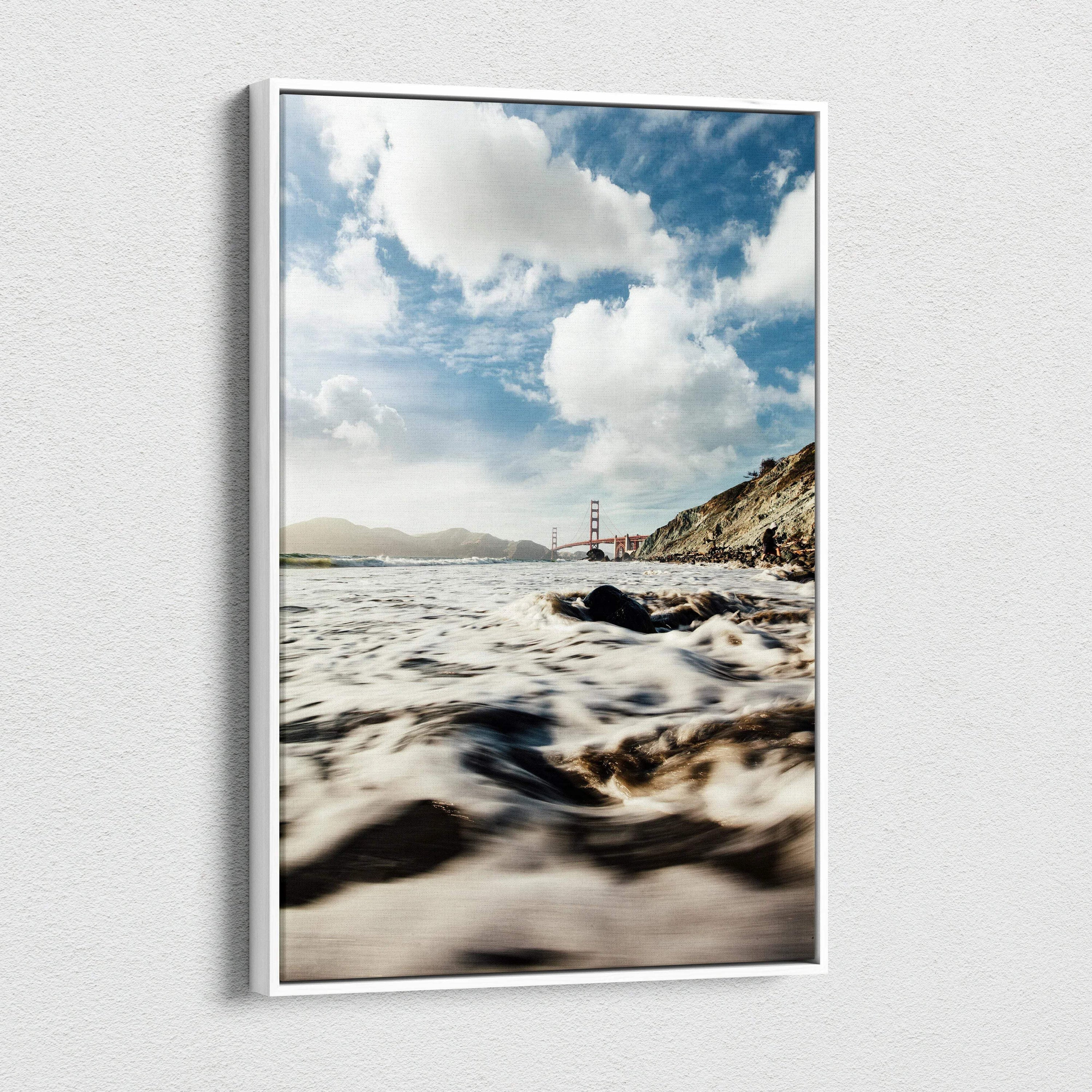 Canvas wall art depicting a serene beach scene with waves and the Golden Gate Bridge under a cloudy sky.