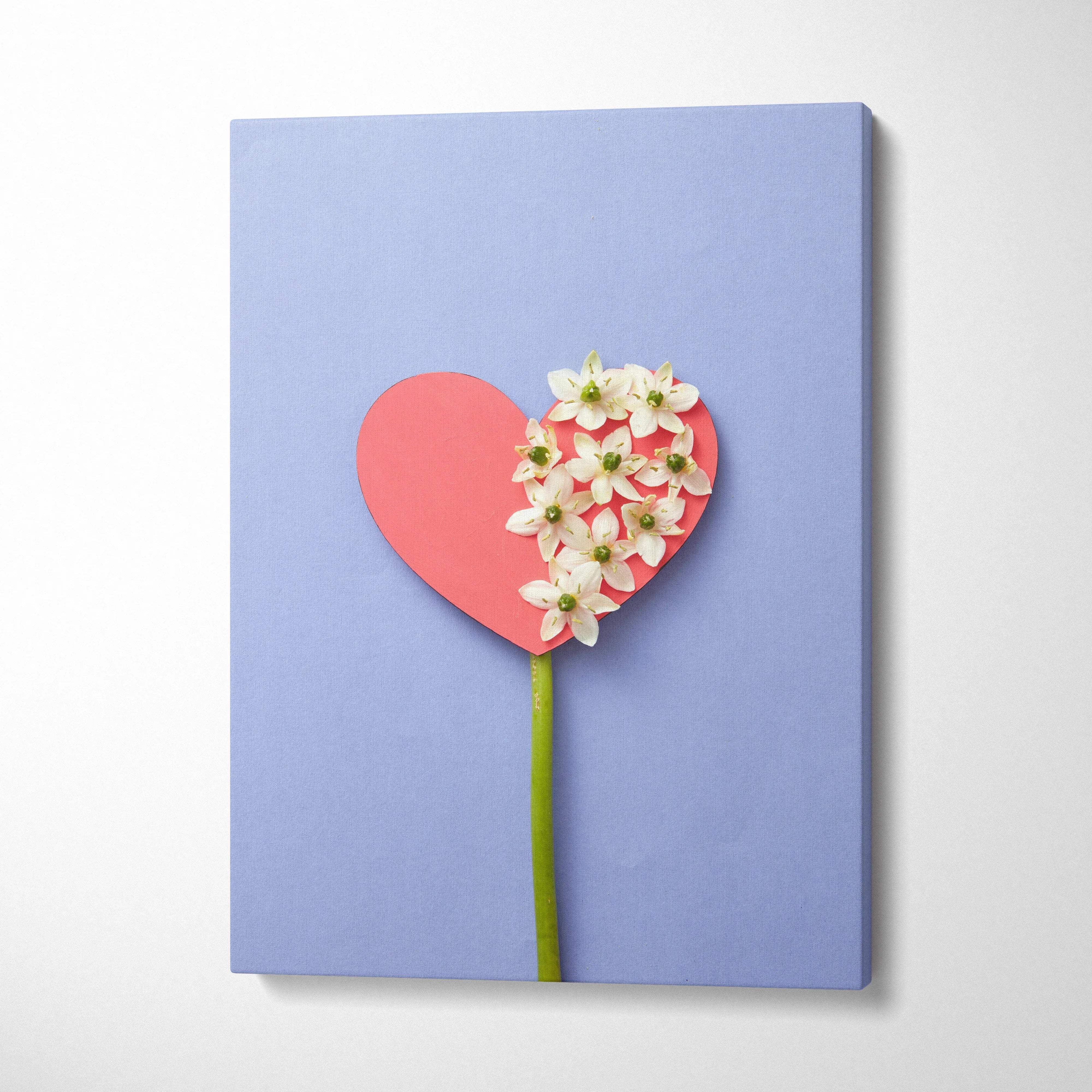 Pastel blue heart canvas wall art with white flowers on pink, minimalist decor