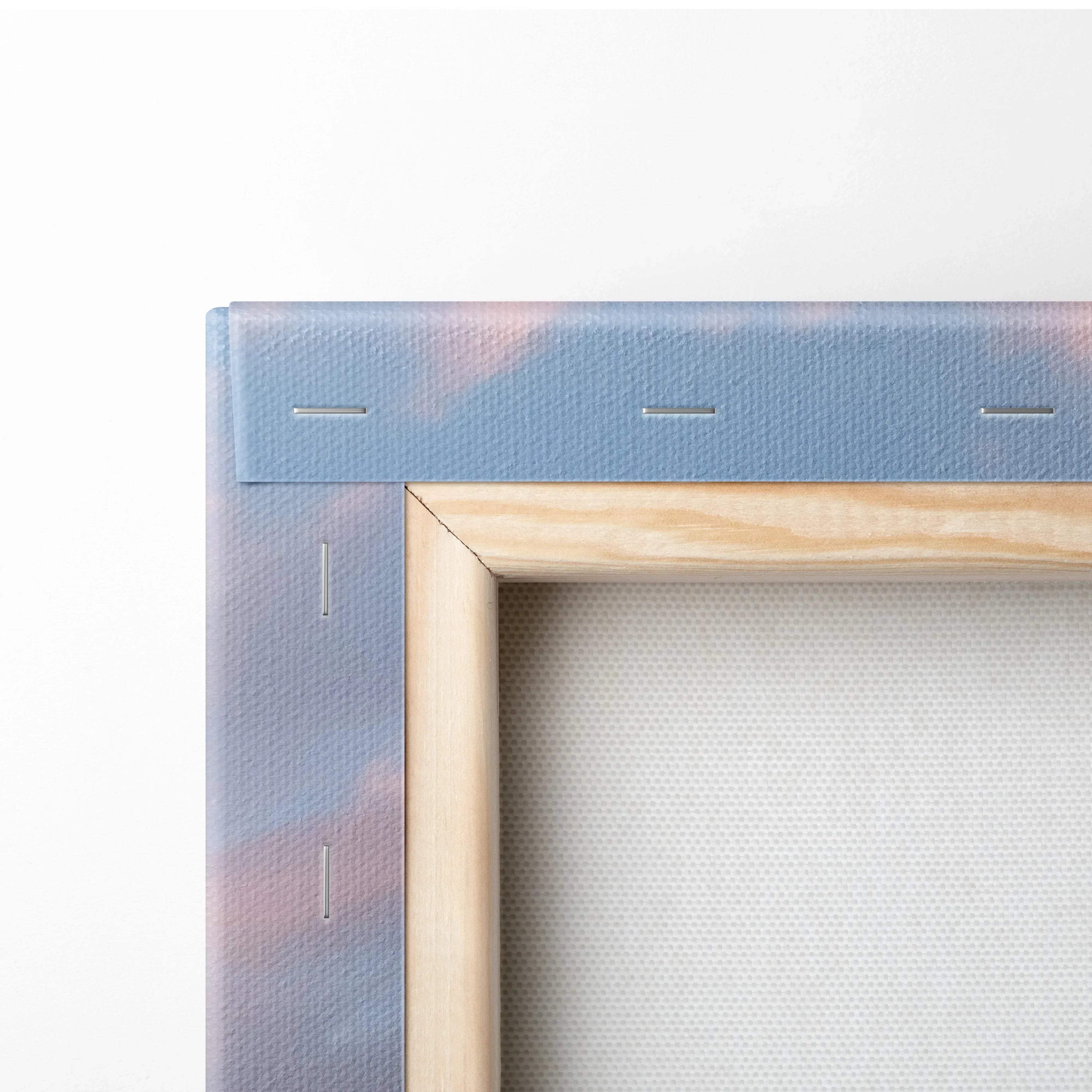 Close-up of wooden frame and stretched canvas edge showing sunset hues, wall art detail.