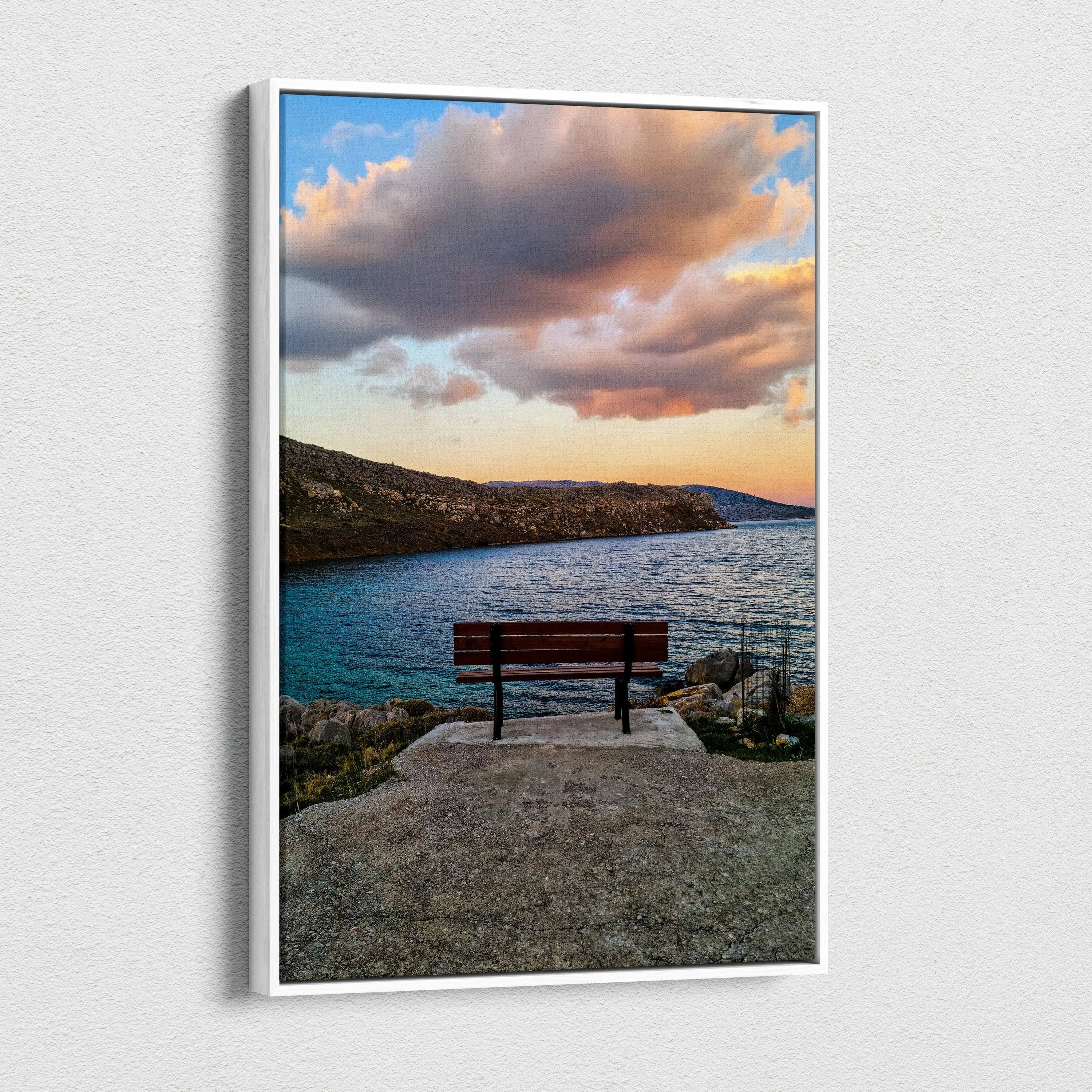 Sunset landscape canvas wall art with a bench overlooking ocean and rocky coast under vibrant clouds.