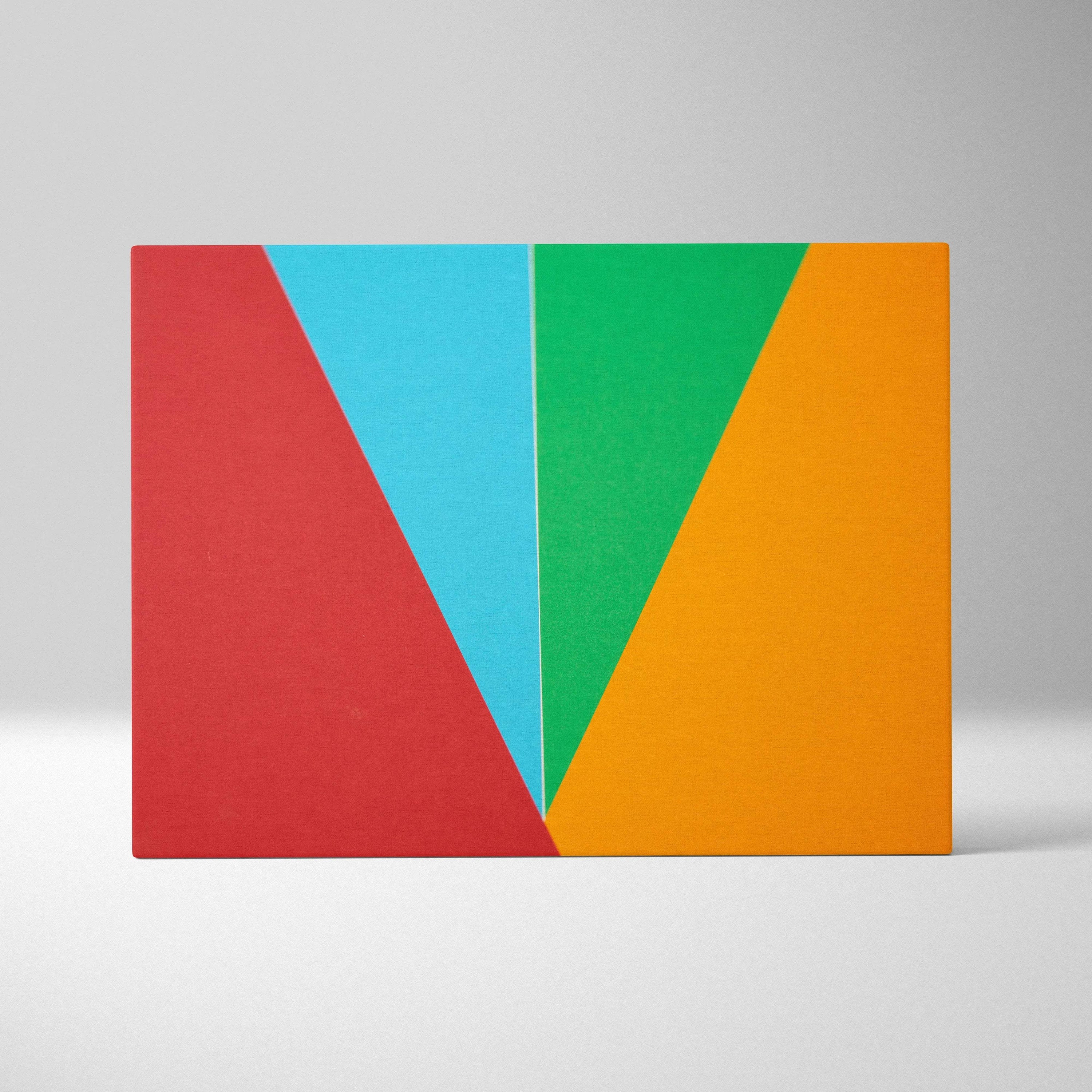 Vibrant geometric abstract canvas wall art with bold overlapping red cyan green orange triangles