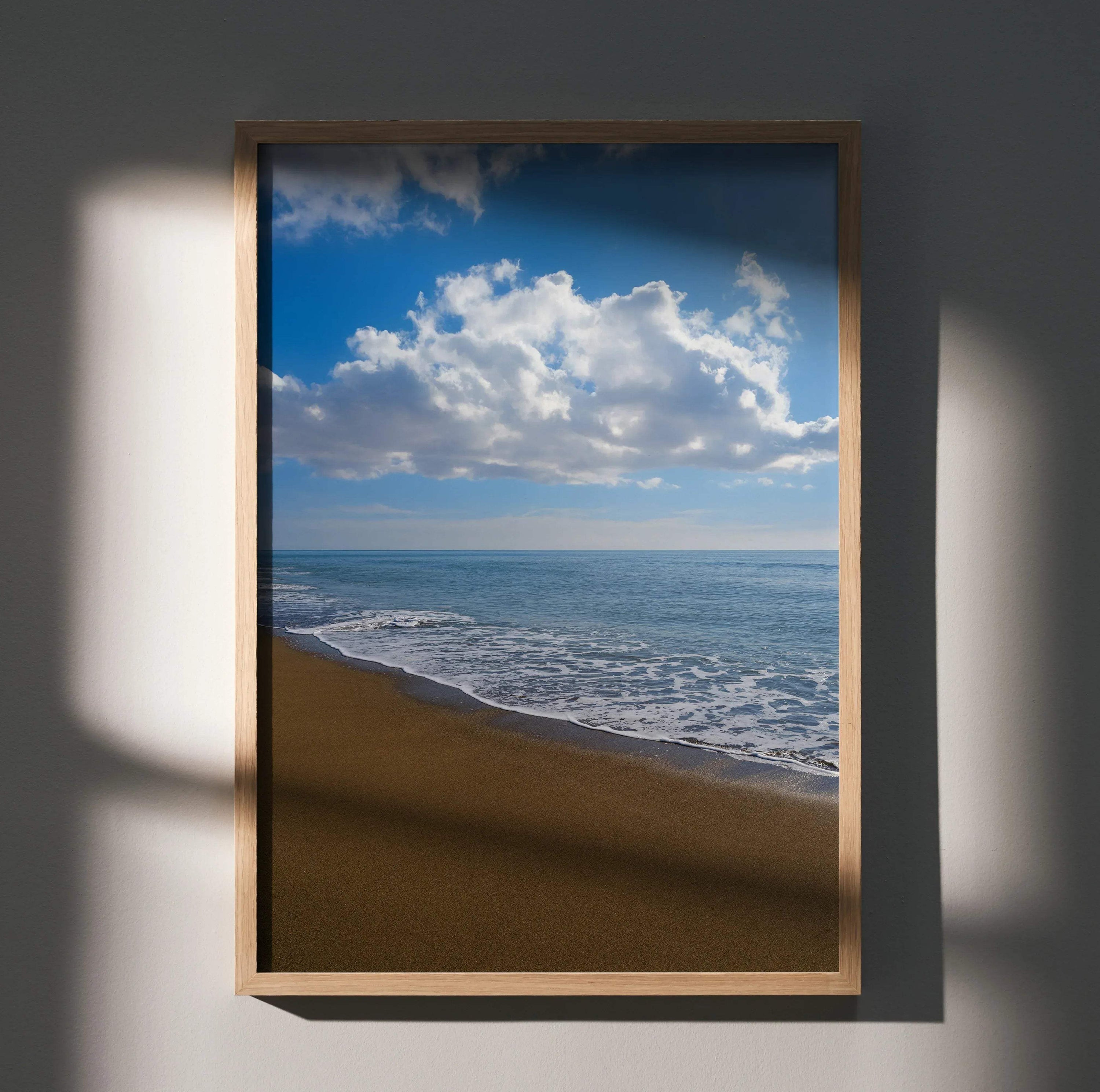 Vibrant beach ocean waves poster with blue sky and fluffy clouds wall art in wooden frame.