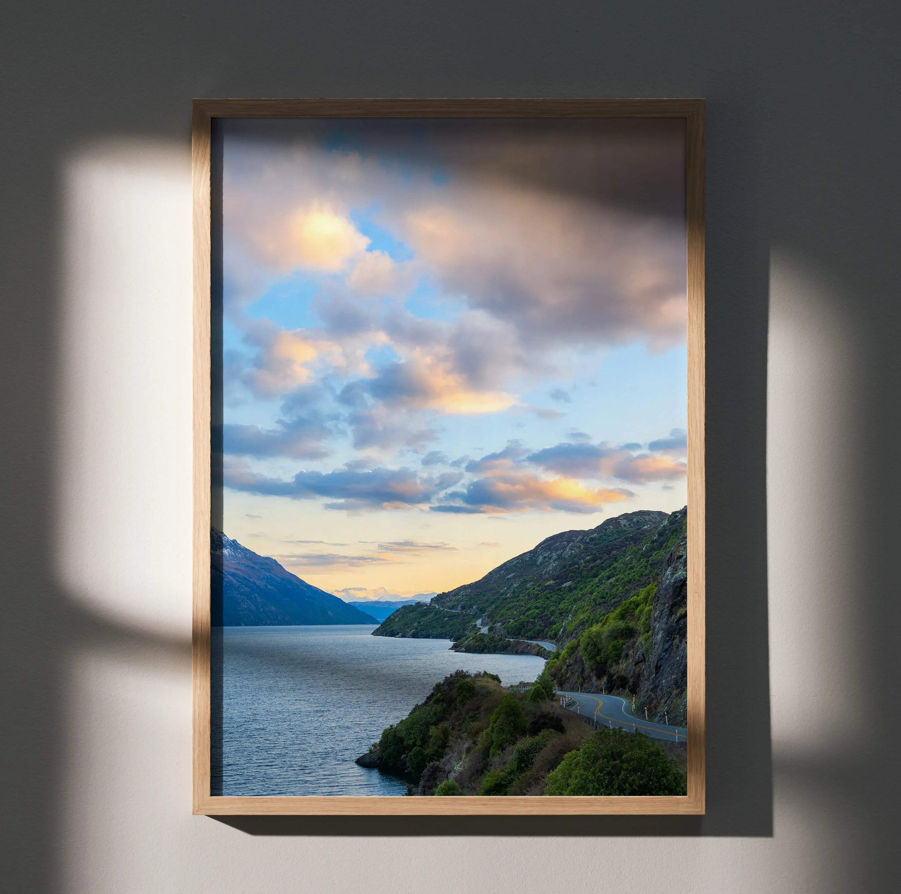 Vertical wall art poster featuring vibrant mountains and sunset over a lake with dramatic clouds.