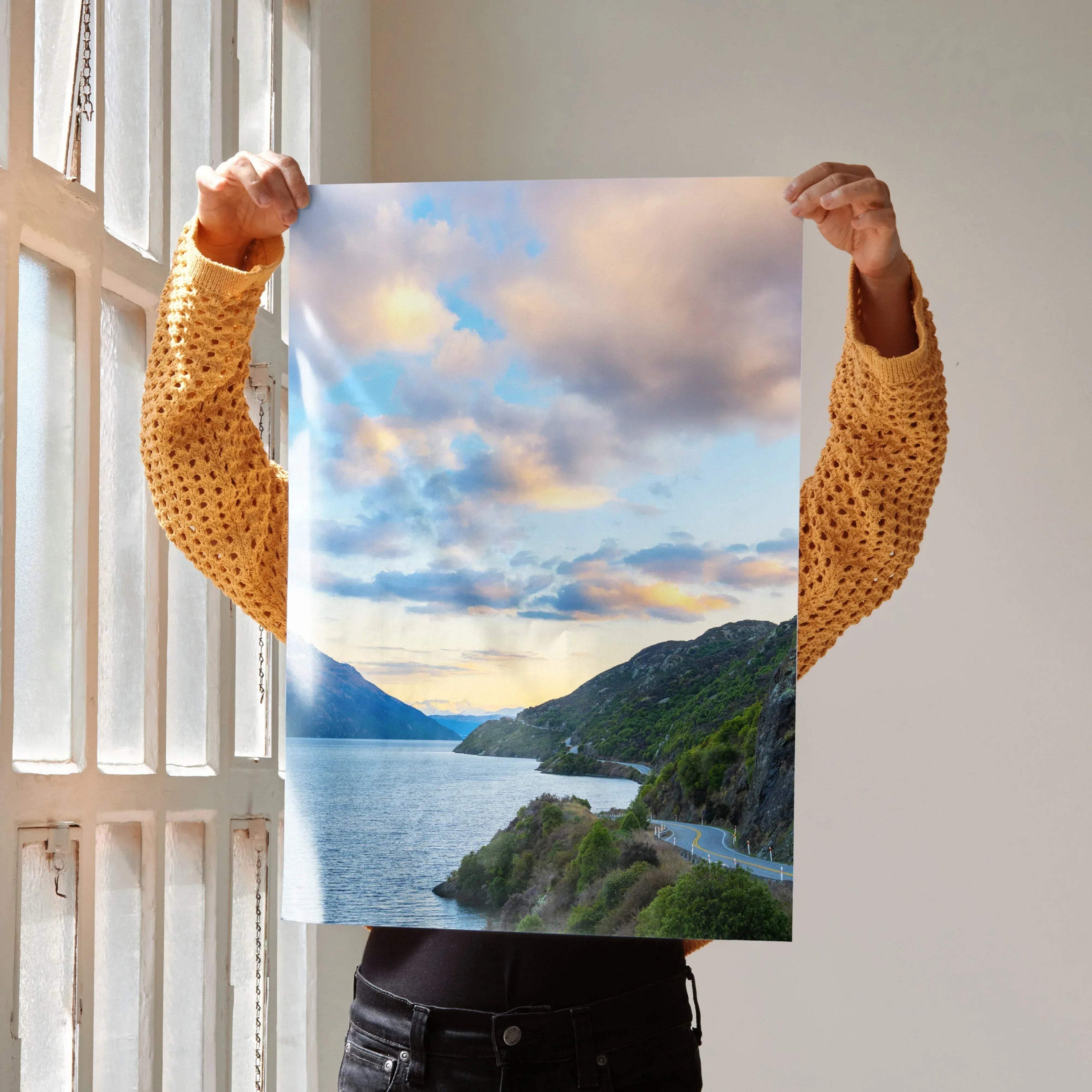 Vertical wall art poster featuring vibrant mountains and a colorful sunset over a scenic coastal road.