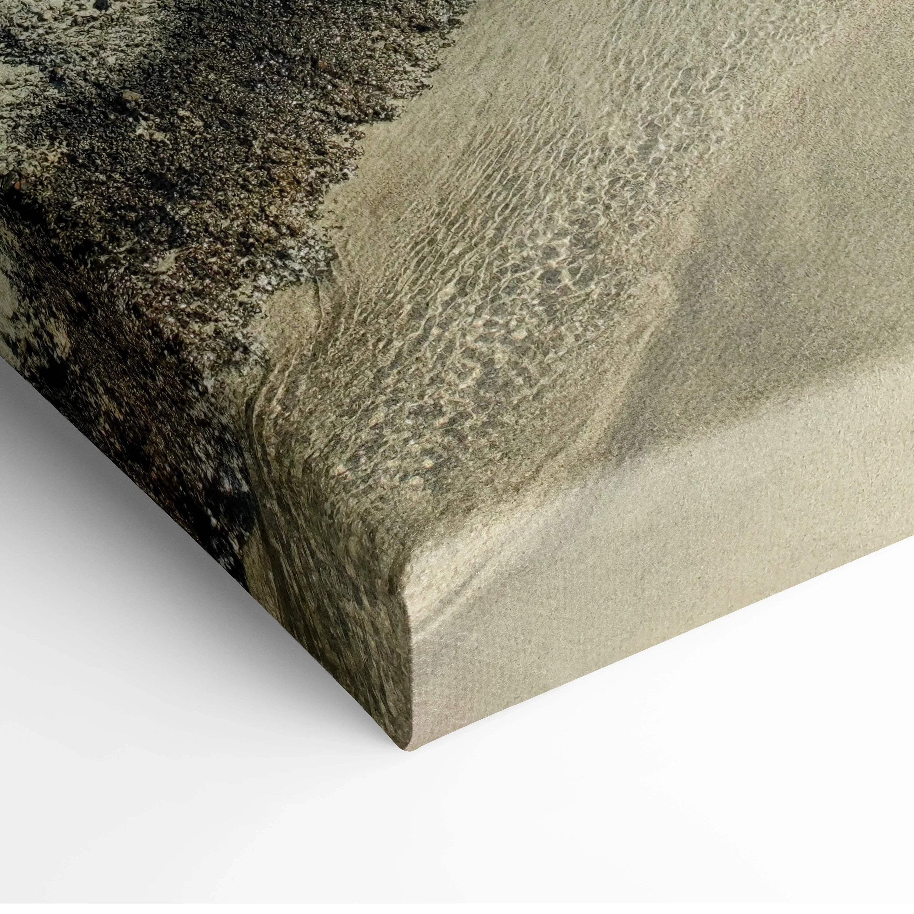 Canvas wall art featuring textured close-up of sandy beach and flowing water.