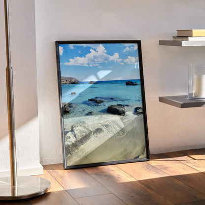 Vertical beach landscape poster with clear blue water and rocky shore wall art.