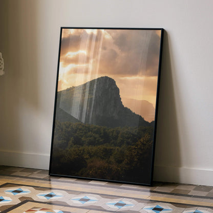 Majestic mountain silhouette at sunset with glowing sky poster wall art in black frame.