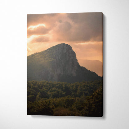 Mountain sunset canvas wall art with dramatic clouds and forested foreground.