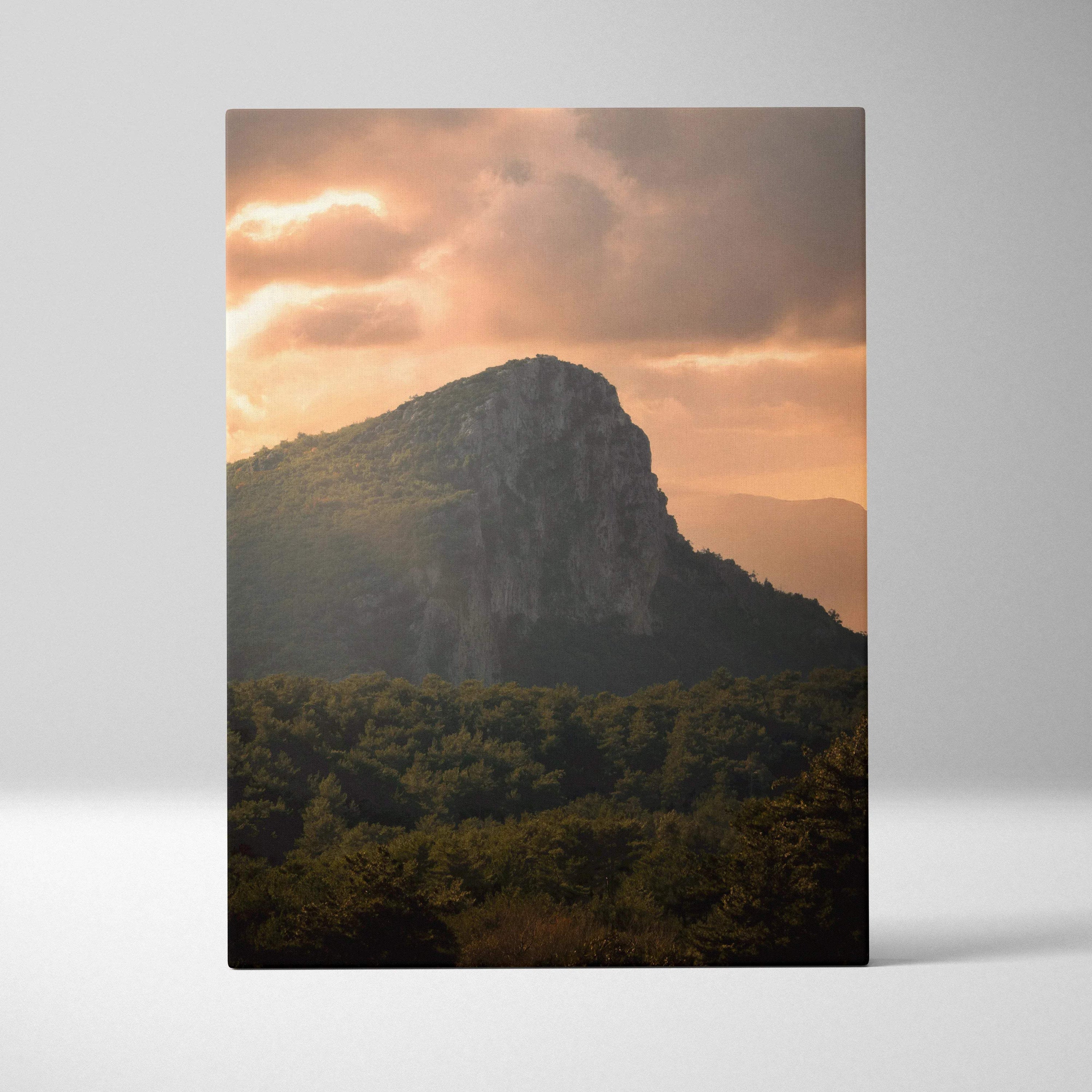 Majestic mountain sunset over forest with warm orange sky canvas wall art.
