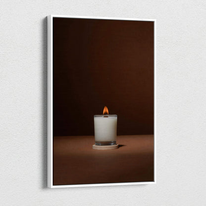 Minimalist white candle in glass jar with warm glow on brown backdrop