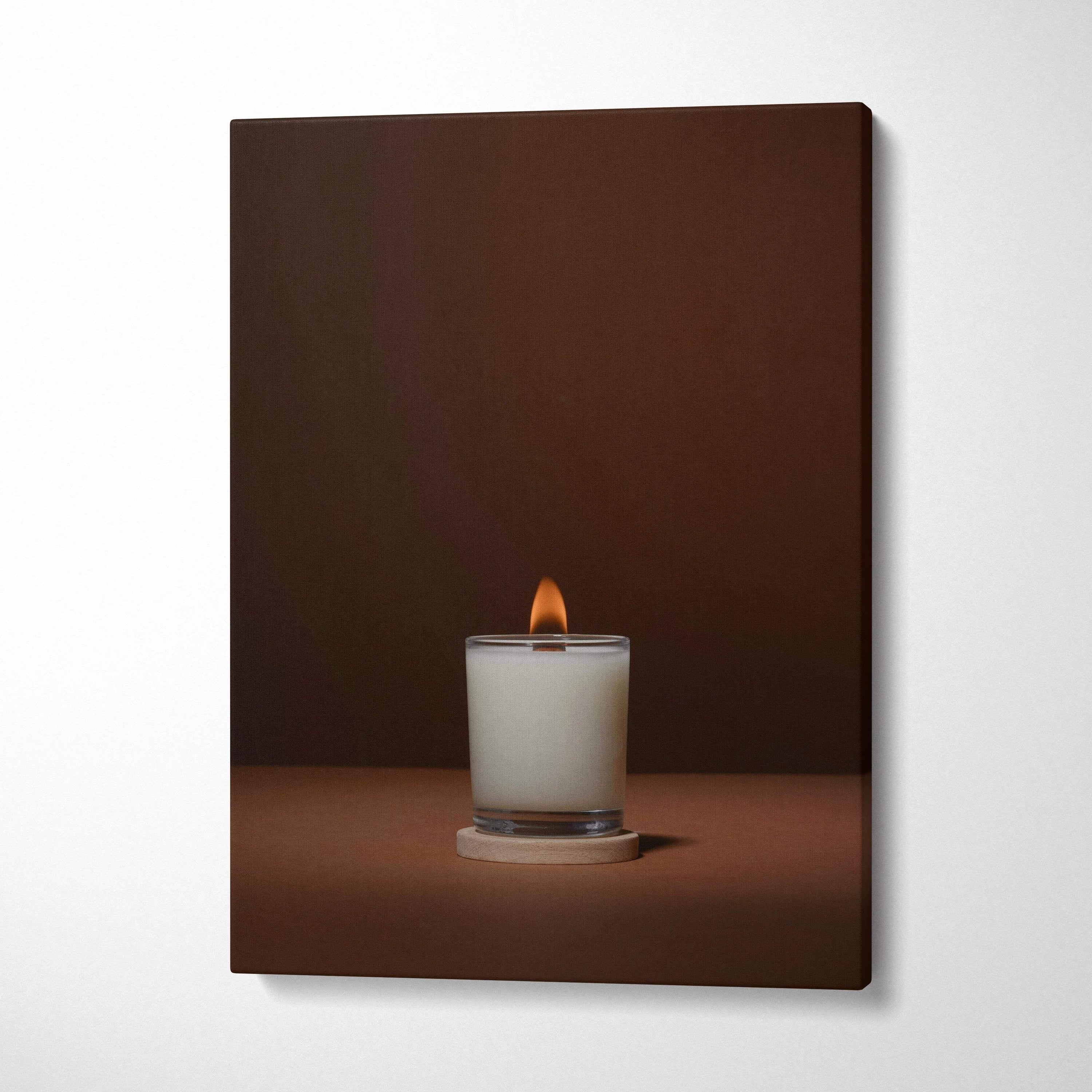 Minimalist lit white candle in glass jar on warm brown canvas wall art