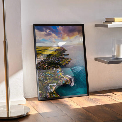 Vertical wall art poster of ocean coastline at sunset with vibrant skies and coastal village.