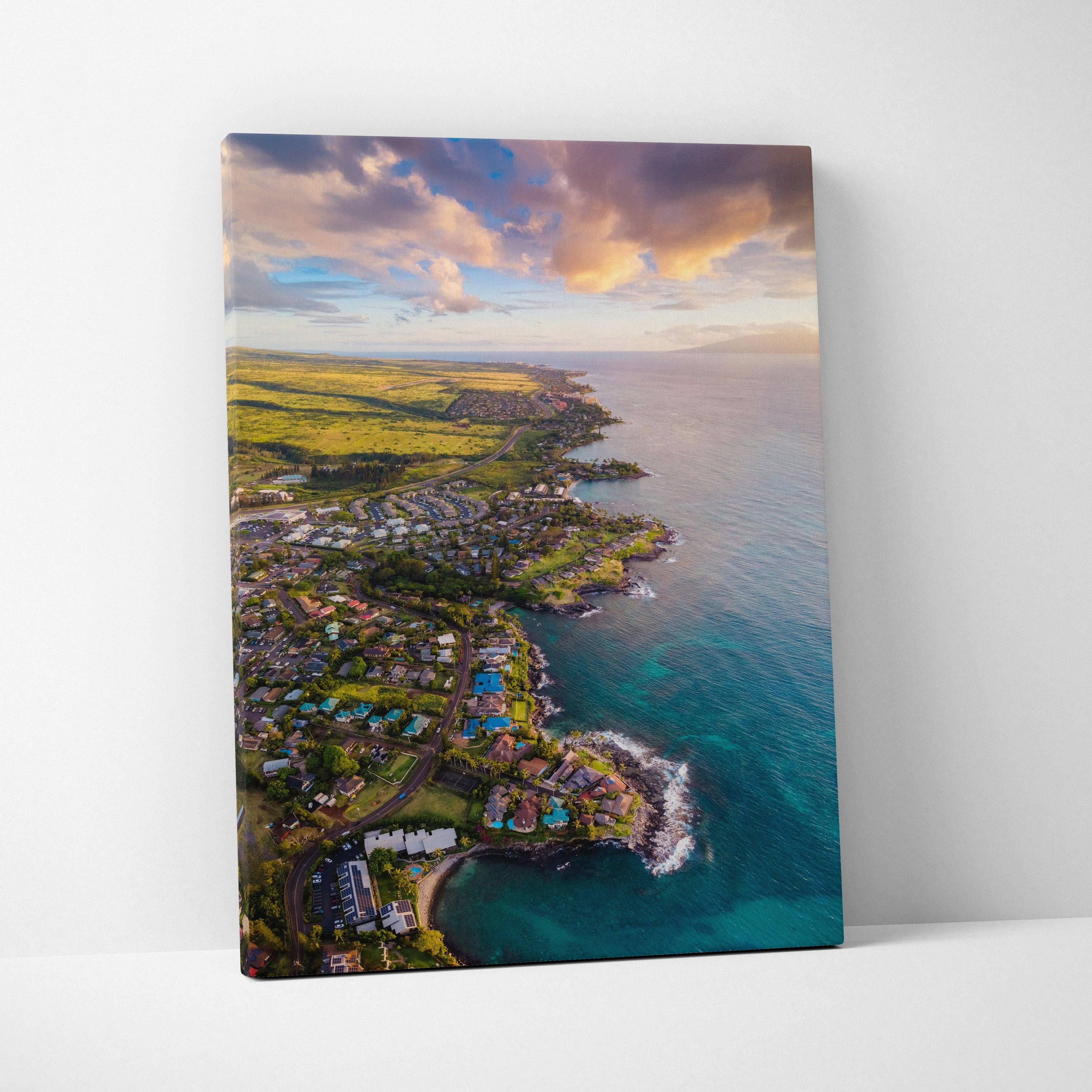 Vertical canvas wall art featuring colorful coastal city skyline at sunset with ocean and clouds.