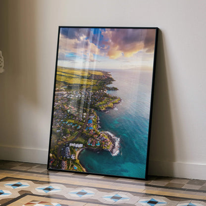Vertical beach wall art poster featuring a serene ocean sunset over a coastal town with vibrant sky colors and calm water.